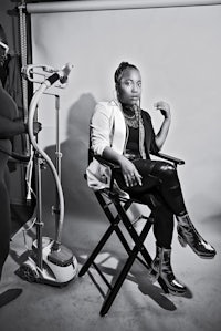 a black and white photo of a woman sitting in a chair